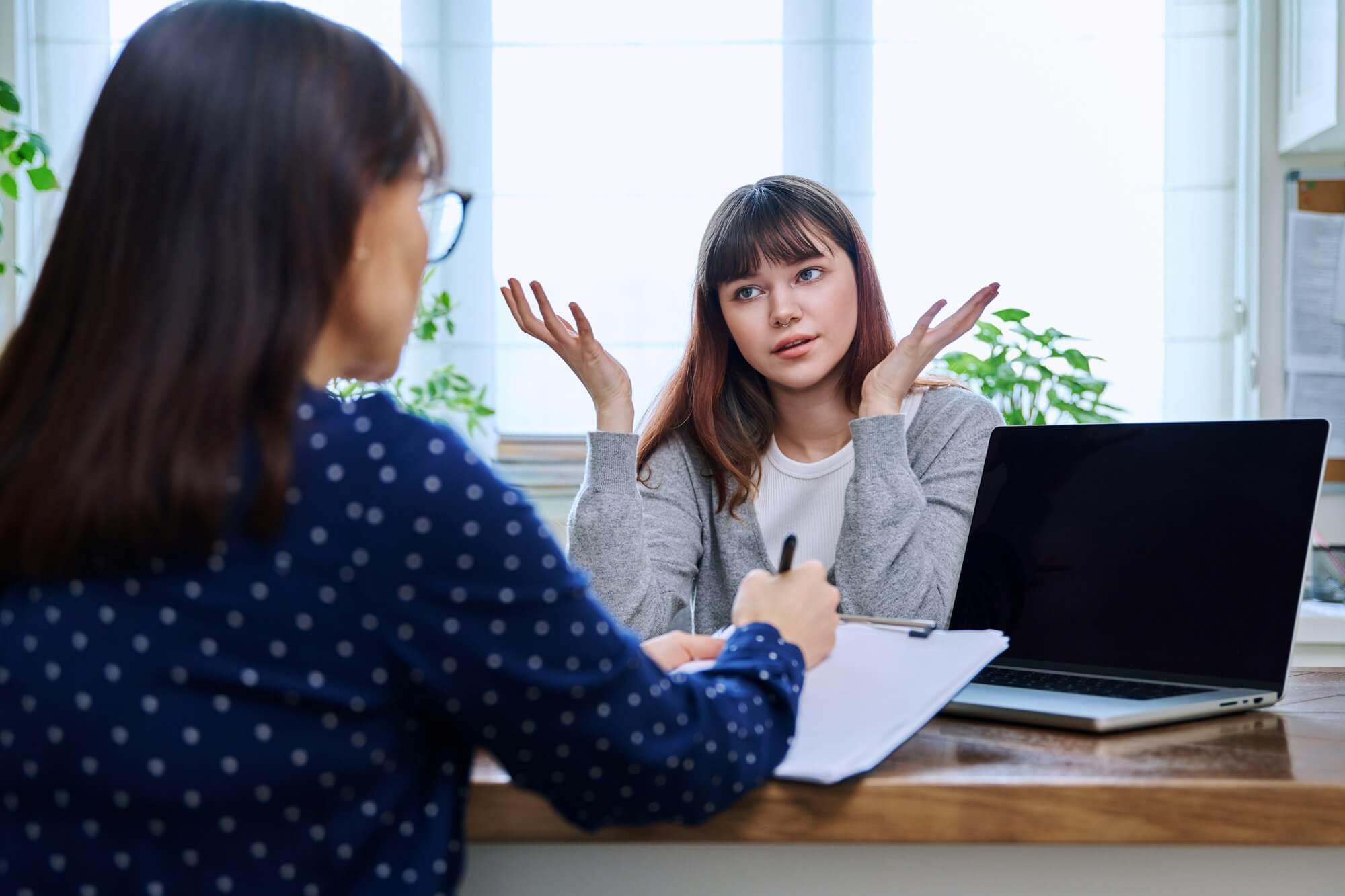 teenage-girl-at-therapy-session-with-mental-health-professional.jpg